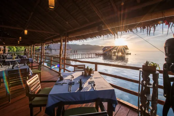 papua_paradise_ecoresort_Restaurant-Table-For-Two-Sunset